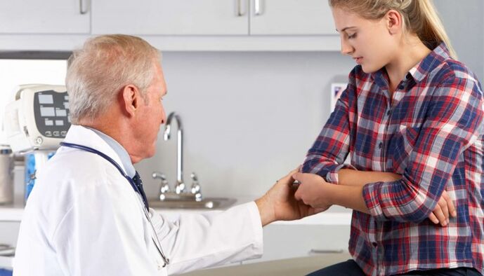 Doctor checking hand joint for pain